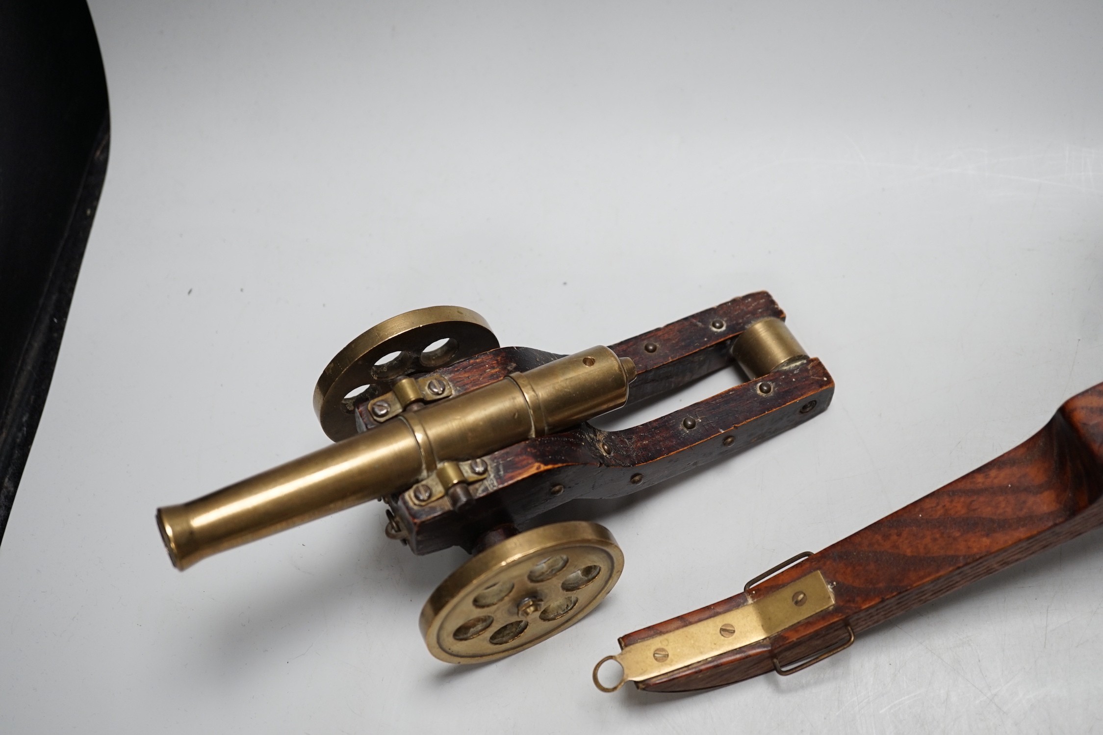 A bronze 'Napoleon bust' desk seal, 8.5cm tall, together with four models of cannons. Largest 39cm wide